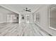 Bright open floor plan features wood floors, ceiling fan, and natural light at 7231 Big Bend Dr, Spring Hill, FL 34606