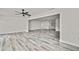 Open-concept living area with wood floors and bright natural light at 7231 Big Bend Dr, Spring Hill, FL 34606