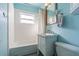 Clean bathroom with a bathtub, vanity, and light blue walls at 9696 Groveland St, Seminole, FL 33772