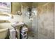 Bathroom with pedestal sink and a glass-enclosed shower at 9696 Groveland St, Seminole, FL 33772