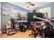 Bright bedroom featuring a large desk and gaming chair at 9696 Groveland St, Seminole, FL 33772