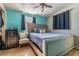 Bedroom with light teal walls and a queen-size bed at 9696 Groveland St, Seminole, FL 33772