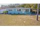 Cute light blue house with a small front yard at 9696 Groveland St, Seminole, FL 33772