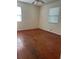 Sunny bedroom showcasing natural light and hardwood flooring at 1000 Country Club N Rd, St Petersburg, FL 33710