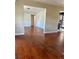 Open living room with hardwood floors, connecting to the kitchen area at 1000 Country Club N Rd, St Petersburg, FL 33710