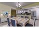Bright dining area with a farmhouse table and seating for six at 1430 Gulf Blvd # 204, Clearwater Beach, FL 33767