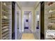 Large walk-in closet with ample shelving and mirrored doors at 1430 Gulf Blvd # 204, Clearwater Beach, FL 33767