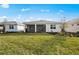 Well-maintained backyard with a spacious lawn and a covered patio, perfect for entertaining or relaxing outdoors at 17925 Nadine Pl, Nokomis, FL 34275
