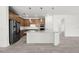 Bright kitchen featuring a large island with white cabinetry, wood cabinets, and stainless steel appliances at 17925 Nadine Pl, Nokomis, FL 34275