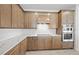 Close-up of kitchen showcasing wood cabinetry, marble countertops, stainless steel appliances, and a white backsplash at 17925 Nadine Pl, Nokomis, FL 34275