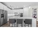 Modern kitchen with white cabinets, stainless steel appliances and island at 17925 Nadine Pl, Nokomis, FL 34275