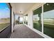 The spacious screened patio boasts brick flooring and sliding glass doors, seamlessly connecting indoor and outdoor living at 17925 Nadine Pl, Nokomis, FL 34275