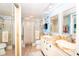 Bright bathroom featuring double sinks, granite counters, and a shower at 3207 Green Dolphin St, Tarpon Springs, FL 34689