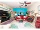 Living room with red sofa, teal accent wall, and large TV at 3207 Green Dolphin St, Tarpon Springs, FL 34689