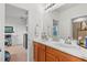 Double vanity bathroom with a view into another bedroom at 33975 Astoria Cir, Wesley Chapel, FL 33545