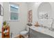 Modern bathroom with gray vanity, marble countertop, and a round mirror at 33975 Astoria Cir, Wesley Chapel, FL 33545