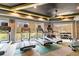 Community fitness center with treadmills, weights, and large windows at 33975 Astoria Cir, Wesley Chapel, FL 33545
