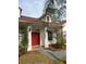 Home's exterior features a red door and a red tile roof at 3754 Bramblewood Blvd, Land O Lakes, FL 34639