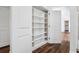 Custom closet featuring built-in shelving, and a door to a living area at 4628 W Longfellow Ave # 1/2, Tampa, FL 33629