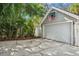 Spacious garage with a basketball hoop, nestled among lush tropical landscaping at 4628 W Longfellow Ave # 1/2, Tampa, FL 33629