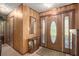 Entryway with a stained glass door and wood-paneled walls at 5105 N 45Th St, Tampa, FL 33610