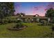 Single-story home with landscaped lawn and attached garage at dusk at 5105 N 45Th St, Tampa, FL 33610