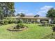 Single-story home with landscaped lawn and attached garage at 5105 N 45Th St, Tampa, FL 33610