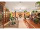 Expansive living room boasts brick fireplace, chandelier, and dining area with lush greenery at 5105 N 45Th St, Tampa, FL 33610