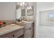 Modern bathroom with double vanity and updated fixtures at 7916 Longwood Run Ln, Tampa, FL 33615