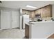 Modern kitchen with wood cabinets and breakfast bar at 7916 Longwood Run Ln, Tampa, FL 33615