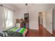 Spacious bedroom with wood floors, closet, and large window providing lots of natural light at 8903 N Edison Ave, Tampa, FL 33604