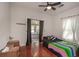 Bright bedroom with wood floors features access to a sunroom at 8903 N Edison Ave, Tampa, FL 33604