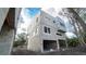 Modern, two-story block home under construction, featuring expansive windows and a two-car garage at 504 Federal St, Oldsmar, FL 34677