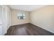 Bedroom showcases wood floors, a ceiling fan, and a large window with natural light at 141 Lakeview Way, Oldsmar, FL 34677