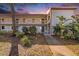 Two-story condo building with landscaped grounds, walkway, and balconies at 141 Lakeview Way, Oldsmar, FL 34677