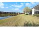 Beautiful lawn area and serene lake view behind the homes at 141 Lakeview Way, Oldsmar, FL 34677