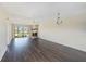 Open living area with fireplace, sliding glass door, and wood flooring at 141 Lakeview Way, Oldsmar, FL 34677