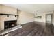 Spacious living room with fireplace, ceiling fan, and wood flooring at 141 Lakeview Way, Oldsmar, FL 34677