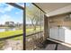 Screened in patio with washer and dryer; overlooks water and landscaping at 141 Lakeview Way, Oldsmar, FL 34677