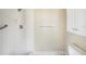 Tiled shower with showerhead, grab bar, and a built-in niche for storage; features a modern design at 141 Lakeview Way, Oldsmar, FL 34677