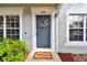 Inviting front door entrance with a welcoming mat and wreath at 2345 Lake Woodberry Cir, Brandon, FL 33510