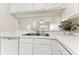 Clean kitchen with white cabinets and a double sink at 2345 Lake Woodberry Cir, Brandon, FL 33510