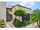Charming two-story condo featuring a staircase, landscaping, and a stucco exterior, creating an inviting curb appeal at 2595 Cyprus Dr # 4-202, Palm Harbor, FL 34684