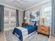 Cozy bedroom with a blue bedspread and hardwood floors at 3512 W Granada St, Tampa, FL 33629