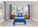 Guest bedroom with blue bedding and wood accents at 3512 W Granada St, Tampa, FL 33629
