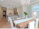 Elegant dining room with chandelier and view into the kitchen at 3512 W Granada St, Tampa, FL 33629