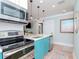 Modern kitchen with teal cabinets and stainless steel appliances at 3512 W Granada St, Tampa, FL 33629
