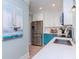 Stainless steel appliances and teal cabinets highlight this kitchen at 3512 W Granada St, Tampa, FL 33629