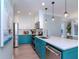 Modern kitchen with teal cabinets, quartz countertops, and stainless steel appliances at 3512 W Granada St, Tampa, FL 33629