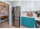 Modern kitchen with stainless steel refrigerator and teal cabinets at 3512 W Granada St, Tampa, FL 33629